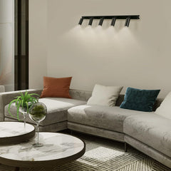Modern living room with a gray sectional sofa, decorative pillows, and a marble coffee table.