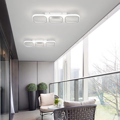Modern indoor setting with ceiling lights and a view of trees outside.