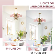 Chandelier with pink glass shades in a dining room setting, showing lights on and off.