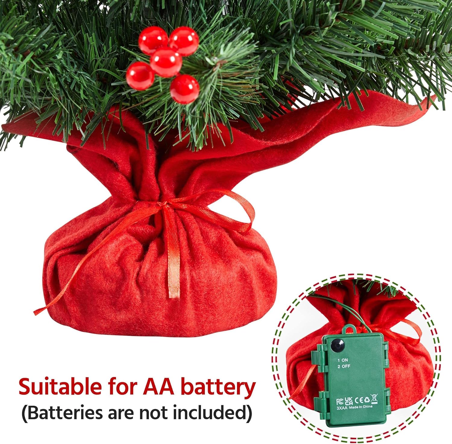 Small artificial Christmas tree with red berries and warm LED lights