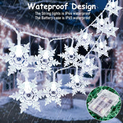 Snowflake string lights with waterproof design features in a snowy outdoor setting.