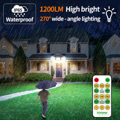 House at night with outdoor lighting system, person with umbrella, and remote control displayed.