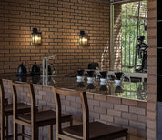 Dining area with brick wall, bar stools, and a counter.