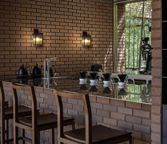 Dining area with brick wall, bar stools, and a counter.