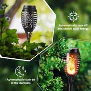 Solar-powered outdoor light fixture with flame effect, surrounded by greenery.