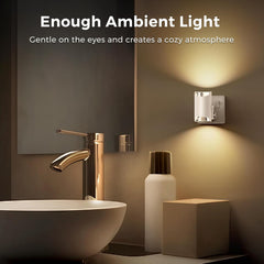 Bathroom setting with a wall light fixture, sink, and mirror, highlighting ambient lighting.