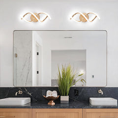 Bathroom with a large mirror, two lights above it, and a black countertop with white sinks.