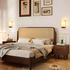 Bedroom with wooden bed, nightstands, and wall art