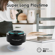 Black and teal SoundAngel speaker on a table with a person in the background