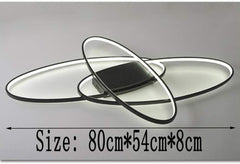 Black elliptical LED fixture above dining table

