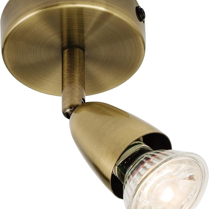 Brass wall light fixture on a white background