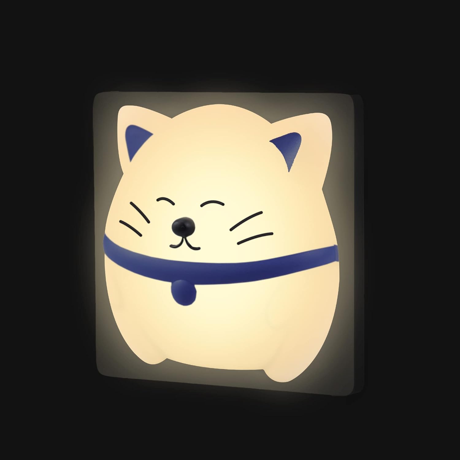 Cat-shaped night light with a blue collar on a black background