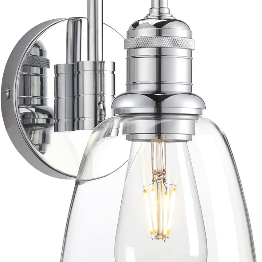 Chrome wall sconce with clear glass shade on a white background