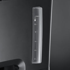 Clear measuring scale on a black appliance with a dark background