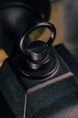 Close-up of a black mechanical component with a textured surface