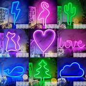 Collage of various neon signs with different shapes and colors on a marble background.