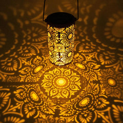 Decorative lantern casting mandala patterns on a textured surface