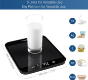 Digital kitchen scale with a glass of milk on it, displaying measurement units.
