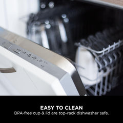 Dishwasher with an open door showing a BPA-free cup and lid inside.