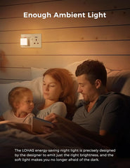 Family reading together in bed with a night light on the wall, emphasizing ambient light.