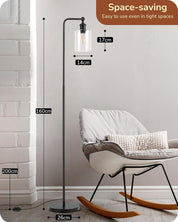 Floor lamp with measurements in a room setting, featuring a chair and white wall.