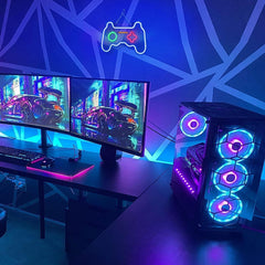 Gaming setup with dual monitors, keyboard, mouse, and RGB LED computer case.