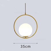 Gold pendant light with a white bulb on a gray background, showing dimensions.
