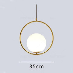 Gold pendant light with a white bulb on a gray background, showing dimensions.