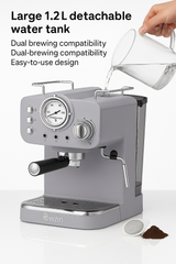 Gray espresso machine with detachable water tank being filled, on a white background.