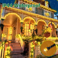 House exterior decorated with IP44 waterproof string lights during a snowfall.