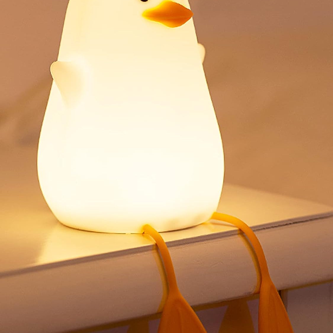 Light-up duck toy on a shelf with a warm glow