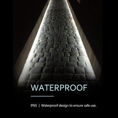 Light fixture with waterproof design text on a dark background