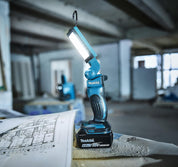Makita work light on a blueprint in an industrial setting
