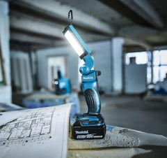 Makita work light on a blueprint in an industrial setting