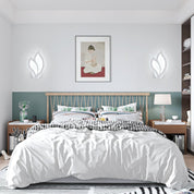 Modern bedroom with a bed, nightstands, and wall art.