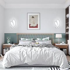 Modern bedroom with a bed, nightstands, and wall art.