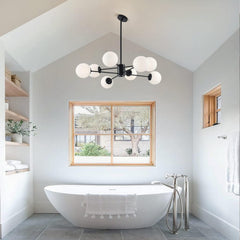 Modern bathroom with a freestanding bathtub, chandelier, and framed window.