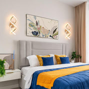 Modern bedroom with a bed, decorative pillows, and wall art.