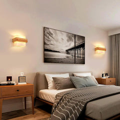 Modern bedroom with a bed, nightstands, and wall art depicting a beach scene.