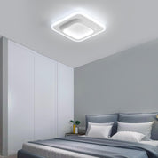 Modern bedroom with a ceiling light fixture, bed, and side table.