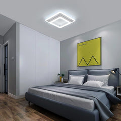 Modern bedroom with gray bed, nightstands, and a yellow abstract painting on the wall.