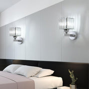 Modern bedroom with two wall-mounted lamps and a bed.