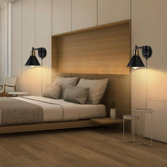 Modern bedroom with wooden headboard, bed, and wall sconces.