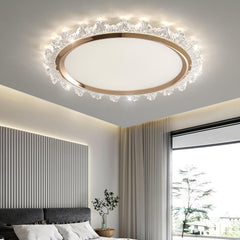 Modern ceiling light fixture in a bedroom with a window and bed in the background