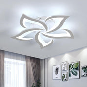 Modern ceiling light fixture in a room with decor elements.