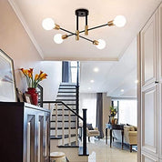 Modern ceiling light fixture in a stylish interior setting with staircase and decor.