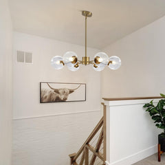 Modern chandelier hanging in a room with a bull artwork on the wall.