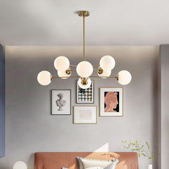 Modern chandelier with round glass lights in a living room setting.