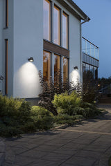 Modern house exterior with wall lights on a clear night
