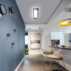 Modern interior design with a blue wall, gold chairs, and a kitchen area.
